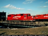 CP Rail Systems GP38-2 #3025 takes a spin on the turntable in Windsor, Ontario on a sunny January 1996 day.  Gone now are the roundhouse, and most likely the GP9, #8222, in the background all in the name of "progress".