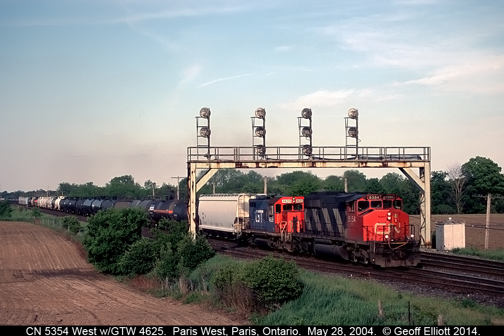 CN SD40-2W #5354 leads a Grand Trunk Geep on a westbound freight as it passes under the Paris West signal on it's way to Sarnia, Ontario back in May of 2004.