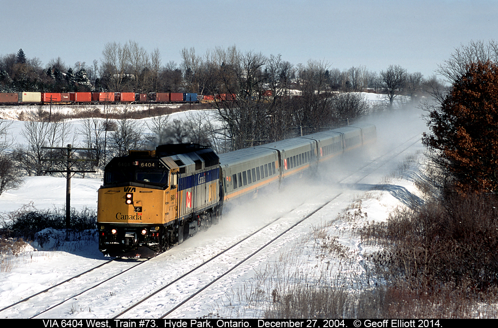 VIA #73 is kicking up the snow as 6404 leads 5 LRC cars through Hyde Park on it's way to Windsor in December 2004.