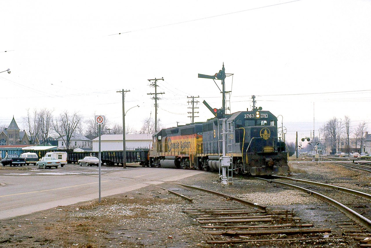 An eastbound C&O train with B&O GP40 3763 and a C&O 42xx GP40-2 is joining the joint track territory on the Conrail (ex-NYC CASO Sub) mainline at St. Thomas ON. Note the train order hoop post to the right of the lead unit, and the semaphore signals to the left.