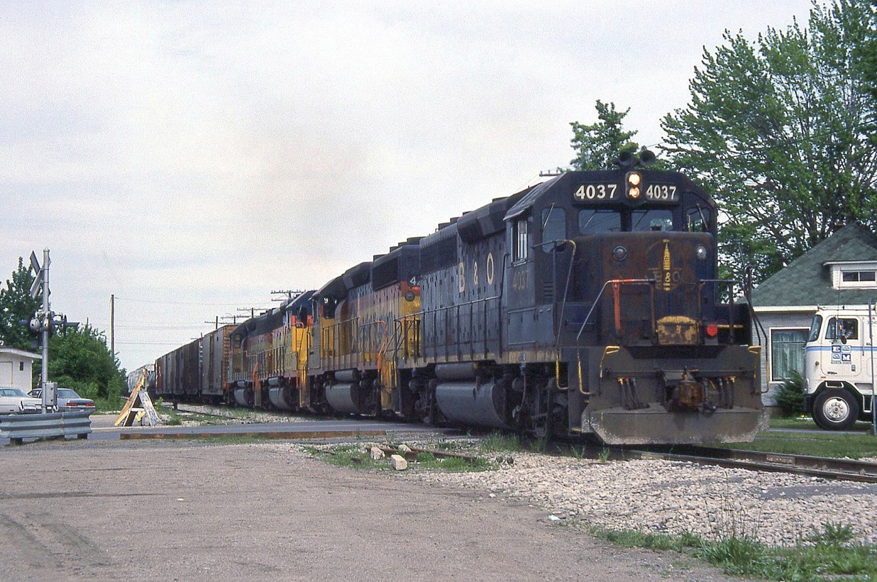 An eastbound Chesapeake and Ohio freight rolls through Leamington ON on Sub 1, with battered B&O GP40 4037 leading three units bearing newer Chessie System paint a year before CSX Transportation became the official company. A few years later, 4037 would be renumbered as CSXT 6612, but still retain its old B&O colours.

Note, geotagged location not exact.