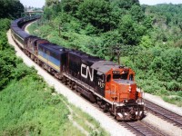 Here is another one of those old pre-VIA passenger train scenes, featuring the usual mish-mash of whatever power for the head end. CN 4017, VIA 6865, CN 3126 lead westbound #75, the days' usually most patronized train thru here, with the standard long consist. I always referred to this location as 'Bayview East' on account the train is approaching Bayview Jct. Nowadays the location is known as "Snake", and it is getting increasingly difficult to get clear photos here due to new signal tower and encroaching foliage. The leader, GP40 CN 4017, was renumbered to 9317 in 1981, and may still be around somewhere as GMTX 2103. Trailing unit RS-18 was part of a series 3100-3129 committed to passenger service back in those days. Snake Rd bridge in the background is still used by fans for photography, but it is imperative that the bridge and approaches be kept clear despite the lane being a dead-end. Private access to a cemetery.