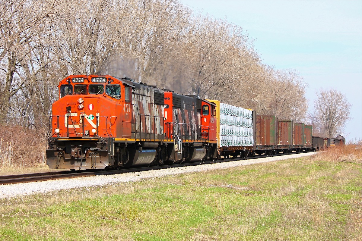 CN 439 thunders Westward with a pair of distinctly Canadian GP38-2W's at a good pace and breaking the silence in the quiet hamlet of Jeanette's Creek.