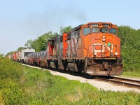 CN 439 finds itself a new leader as it heads back to Windsor in the afternoon sun, both GEEPS roar as they throttle up after crossing Ringold diamond.