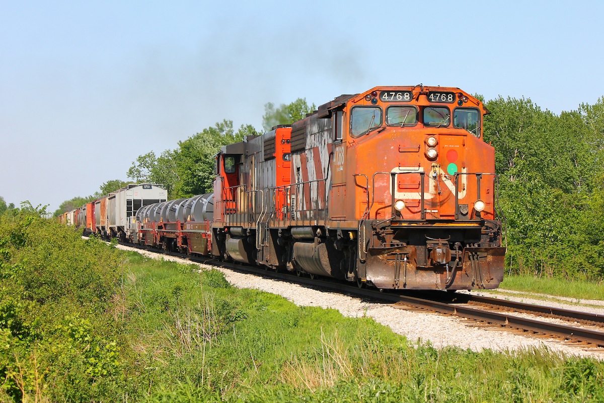 CN 439 finds itself a new leader as it heads back to Windsor in the afternoon sun, both GEEPS roar as they throttle up after crossing Ringold diamond.