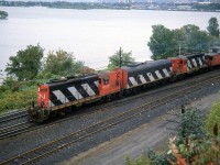 CN GP9's 4572 and 4520, braketed by a CN F7B (likely 9196) handle the Steel Train at Bayview Junction on the Hamilton/Burlington border. By this time, the train was now using the Dundas Sub to Brantford and then down to Nanticoke. In the background is Hamilton Harbour, where CN's Hamilton / Stuart St. Yard is visible (where the Steel train originated), along with various industries and manufacturing plants located nearby.


