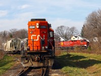 To follow Stephen Host's photo of CP and Amtrak at Bayview, here is the most recent time I caught two different railroads in the same shot. Many photographers know about the Denfield road bridge at Lobo, but there is another place to catch CN and CP together in London. A Sunday CN Racecourse job has run up to the CN/CP interchange to set off one boxcar and lift a number of MT cement cars to bring back to the yard. In the back ground, CP 240 has just got his clearance and is heading out of town. 