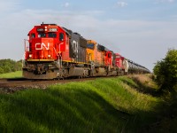 Dodging an impending cloud front, CN 5466 growls up the grade at Ash in sweet evening light with a colourful lash up including four locomotives, three of which being from different railroads.