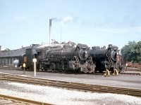 Canadian National 2-8-2 "Mikados" 3466 and 3459 rest outside CNR's famed steam locomotive shops in Stratford ON, in 1958. These had previously been converted into oil burners for Western Canada. Both were built by MLW as part of the S1f class in 1913, and by 1958 their time was nearly up: they would be scrapped in 1959 and 1961 respectively.<br><br>The CN's Stratford backshops, built for the GTR in 1908 for heavy overhauls and maintenance of its steam locomotive fleet, didn't fit in with CN's plans to dieselize its operations and were officially closed on March 31st, 1964. After surviving a few different owners and even a fire, the City of Stratford acquired the former shop buildings in 2010.