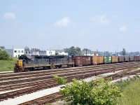 A Chesapeake and Ohio freight, bound for St. Thomas, leaves Fort Erie ON heading westbound. C&O GP35 3573 and a GP38 are the power, with train of American-road freight cars from the states including those from the Pennsylvania RR, Detroit, Toledo and Ironton, Burlington Northern, and Norfolk & Western.