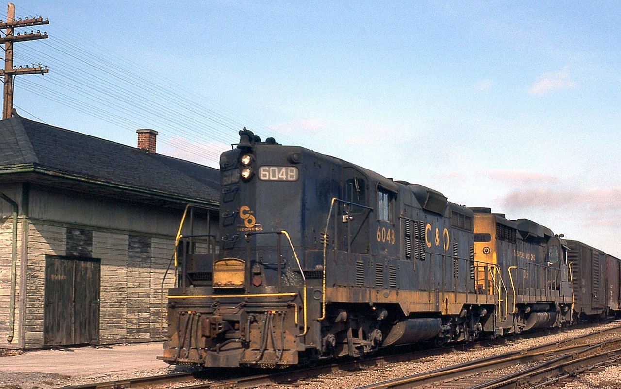 A westbound Chesapeake and Ohio freight with GP9 6048 leading a 3000-series C&O GP30 heads past the old CASO (NYC/PC/CR) Depot on the Conrail CASO Sub at Hagersville ON, almost a year after Conrail was formed.

While the line may have been removed, the Hagersville Depot (or station) survives in use by Southern Ontario Railway, whose line (as the CN/GTR) once crossed the CASO at a diamond just west of the station.