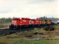 I was heading south on old Hwy 69 (now Nobel Rd here) and hoping to pick up a freight southbound when I heard chatter all of a sudden for a northbound. First spot I could think of was at Felsman Drive just south of Nobel. Not a good location, but at least in the rain I caught all 4 units in the few seconds I had to get the camera out. Good thing, too. Behind CP 5747 and 5740 were two of those elusive Santa Fe units that were on lease to CP for a short period in 1987. Around thirty of them were supposed to be out there, of which just one sported that "SF" paint scheme.  Lucky or what?  Units are 3615 and 3600.