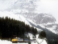 A wintry Mount Stephen looms in the background as the eastbound Canadian climbs Kicking Horse Pass on the CPR.