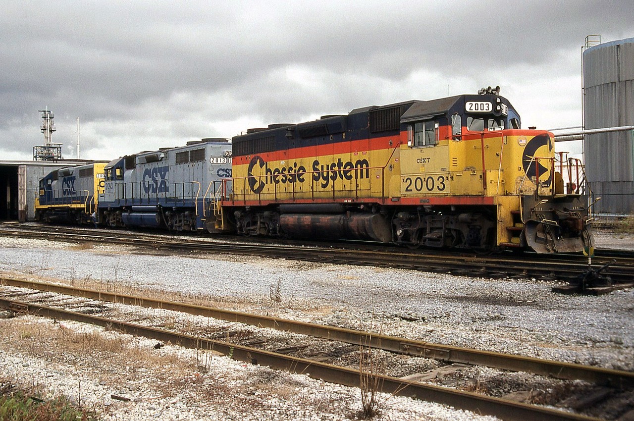 CSX power sits outside the shop at Sarnia ON. Here we have three different paint schemes coupled together: CSXT GP38 2003 wearing the pre-CSX era "Chessie" livery, behind is the original two-tone blue CSX livery on 2013, and another sister 2000-series unit sporting the modified livery with yellow ends that became standard.