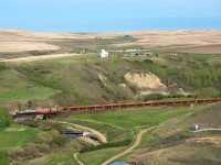 <b><i>Funeral train...</i></b> CN 921 rumbles west along the Drumheller subdivision with one of many loads of rails to be pulled in the coming weeks between Hanna and Lyalta. The scenic rail line through the Alberta Badlands will soon be history.