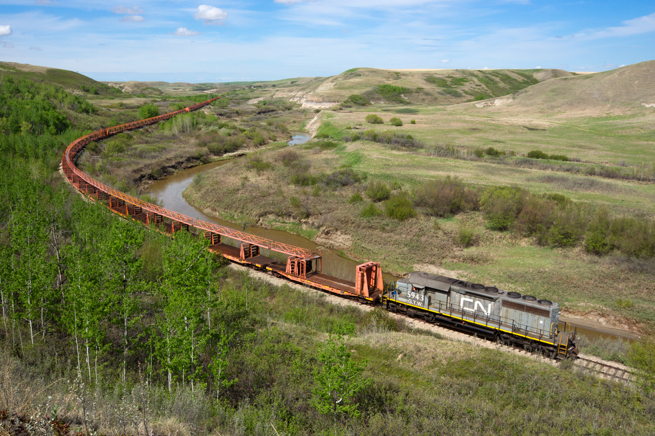 CN 921, the Drumheller subdivision "funeral train", rumbles east between Rosebud and Rosedale on a beautiful spring morning.