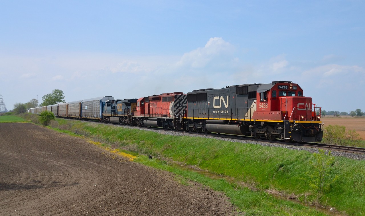 CP 240 led by CN 5438, CP 5749 and CSXT 567 heads east out of Belle River on its way to Tilbury where it will meet a 609 waiting in the siding.