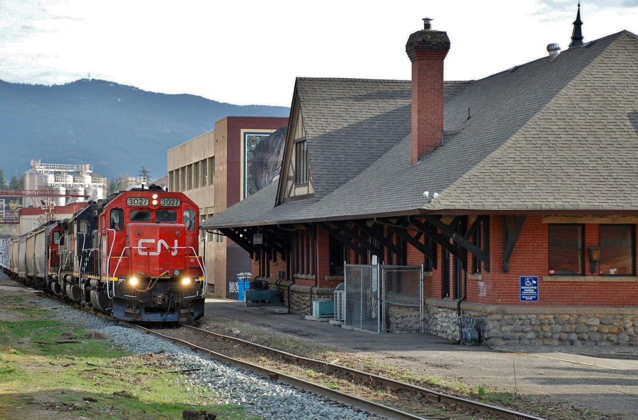 CN(WC) 3027 is in charge of the northbound local freight as it passes Vernon's old CPR station (1911).