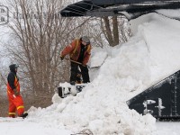 It's a day you wouldn't think would be typical for plowing. The temperature is hovering a few degrees about freezing, rain is forecasted, yet a plow extra was called to flange the snow banks back from Stratford to Goderich. After the morning long venture from Stratford, the GEXR crew associated with the plow pauses just south of the yard in Goderich to clear the snow caked onto ex CN plow 55413.