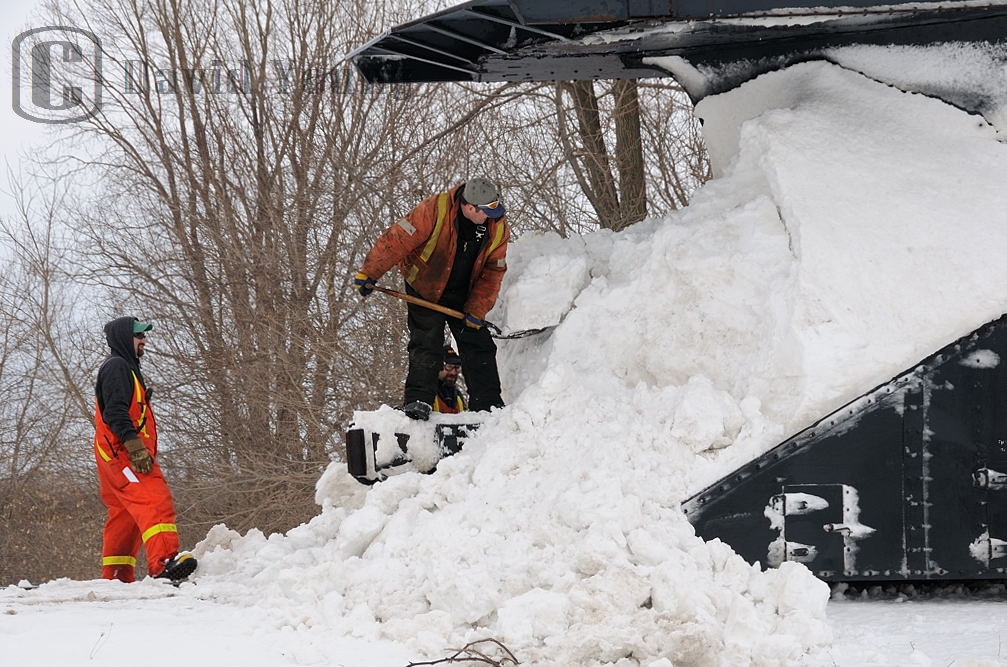 It's a day you wouldn't think would be typical for plowing. The temperature is hovering a few degrees about freezing, rain is forecasted, yet a plow extra was called to flange the snow banks back from Stratford to Goderich. After the morning long venture from Stratford, the GEXR crew associated with the plow pauses just south of the yard in Goderich to clear the snow caked onto ex CN plow 55413.