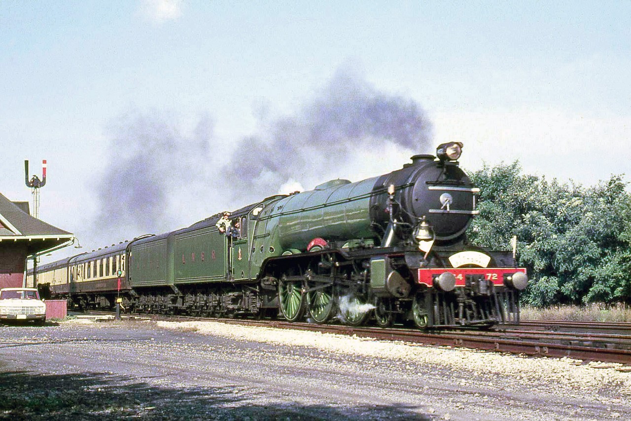 Another image from The Flying Scottsman's visit to Canada in 1970: with the crew hanging out of the cab and railfans under the station awning, LNER 4472 is seen speeding past Jordan Station on a runby along the CN Grimsby Sub, before later being on display at Niagara Falls Station.