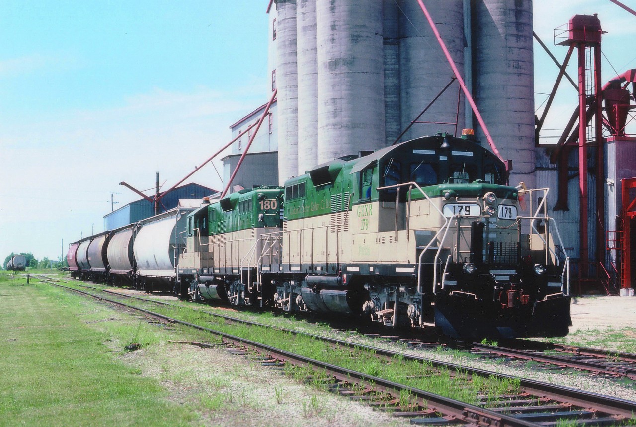 The fledgling GEXR had only been operating a scant two months when this photo was taken in June of 1992. The start-up power stable consisted of units 177-178-179 and 180. Here we see 179 leading 180; en route to Stratford from Goderich after working its way along the line. The train is picking up on the Thompson Feed siding. Thompson is renown for its birdseed among other things.