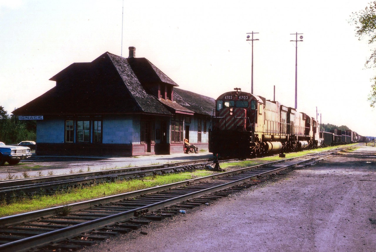 Westbound CP stops at Ignace station for a crew change while it appears a couple of geezers are snoozing the day away out front. What a life!! I was doing a wander in the NorthWest of the province on this trip and still regret misplacing my notes, thus the leader CP 4703 is the only identifiable unit. Nice station. It was designated a railway heritage structure under the provisions of the Railway Station Protection Act as of Feb. 15, 1994.