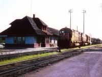 Westbound CP stops at Ignace station for a crew change while it appears a couple of geezers are snoozing the day away out front. What a life!! I was doing a wander in the NorthWest of the province on this trip and still regret misplacing my notes, thus the leader CP 4703 is the only identifiable unit. Nice station. It was designated a railway heritage structure under the provisions of the Railway Station Protection Act as of Feb. 15, 1994.
