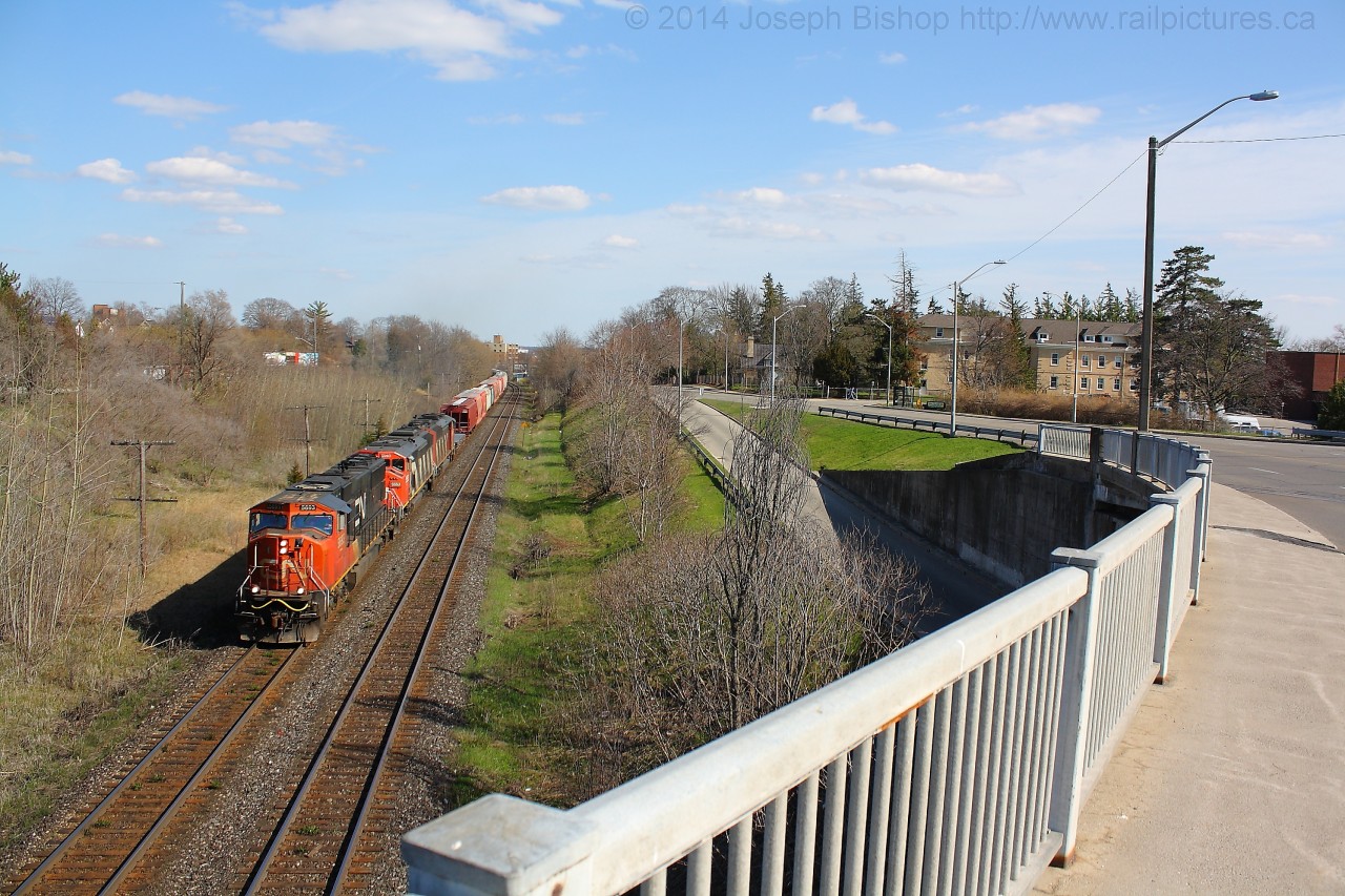 After completing their drop and lift at Brantford, 435 notches up with CN 5693, CN 5553 and CN 5563.  They are about to go under Brant Ave on their approach to Hardy Road and points West.