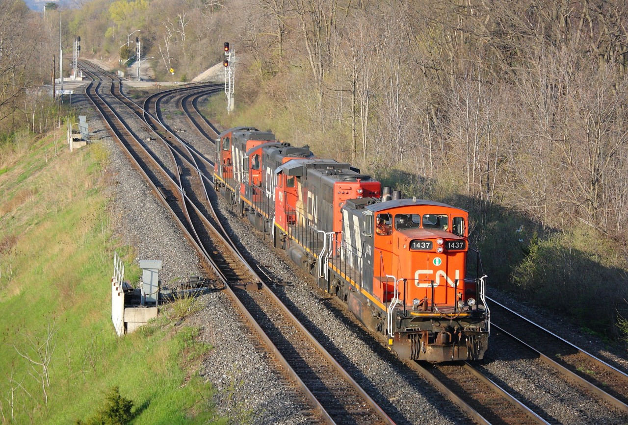 CN 555 makes its way through Bayview Junction with CN 1437, CN 4785, CN 7039 and CN 4138.  CN 383 had encountered issues going up the grade on the Dundas Sub, so 1437 and 4785 went to assist them up the hill by shoving on the tail end.  They ended up pushing 383 all the way to Ingersoll, then the pusher crew booked rest and the power was left in Ingersoll.  7039 and 4138 were sent from Aldershot to retrieve 1437 and 4785 from Ingersoll some time in the early morning and are seen in the image returning to Aldershot after using the wye at Bayview.