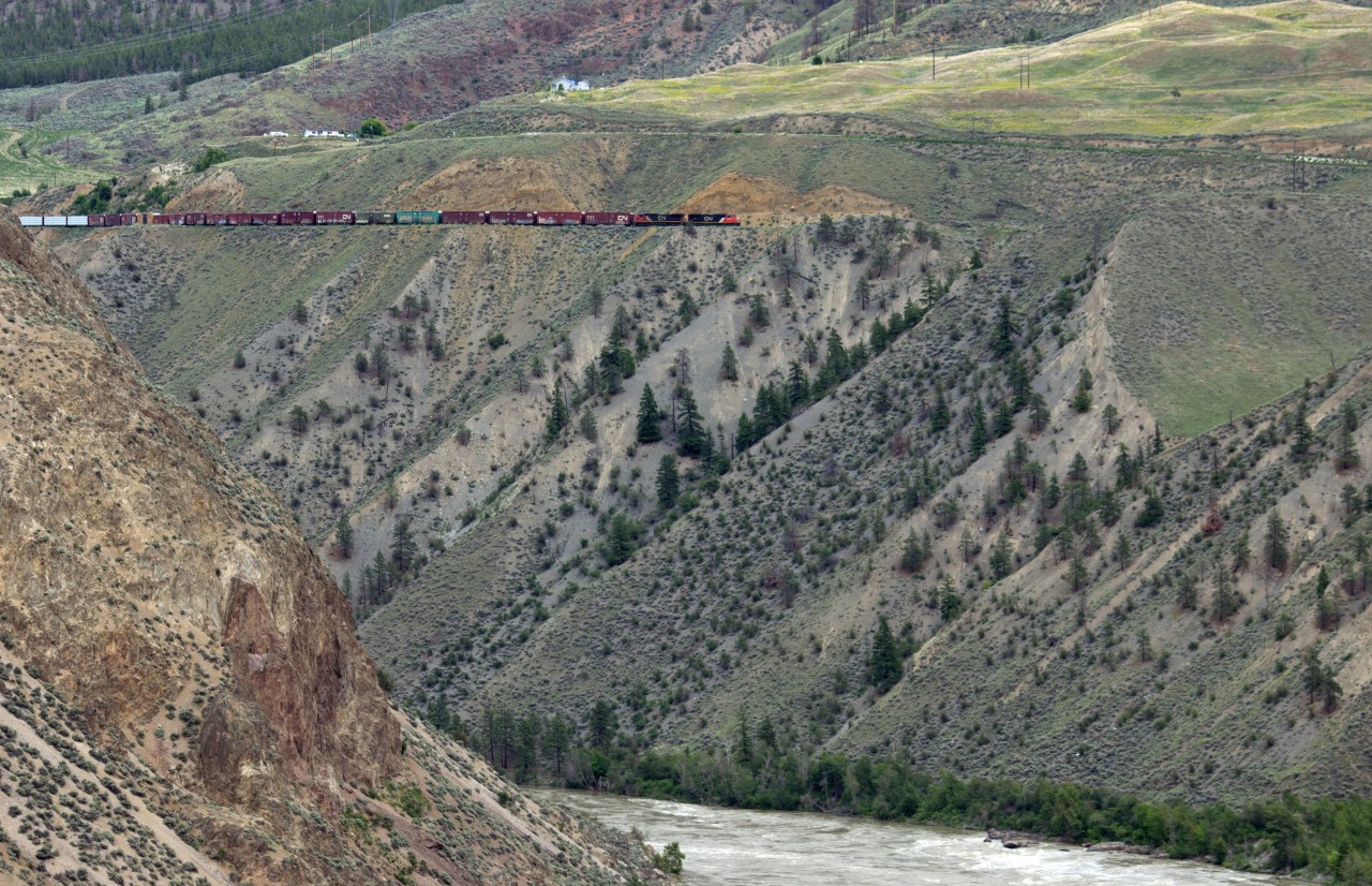 Southbound freight above the Fraser River, descending towards Lillooet, on the former B. C. Rail mainline.