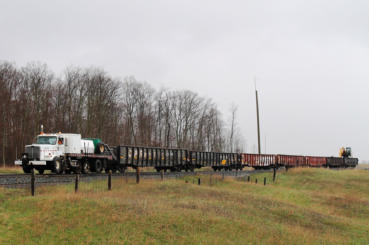 On another wet Friday, CP seem to have found a way to overcome power shortages! The hi rail is pulling gondolas west, the last with attached crane. Having seen a line of track equipment in Woodstock CP Yard I can only assume it was racing to join them. It was speeding out of the yard because #243 was nearly ready to follow after it had sorted cars.