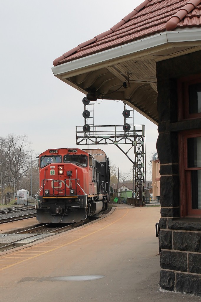 A westbound all empty autoracks motors through Brantford station on the south track.