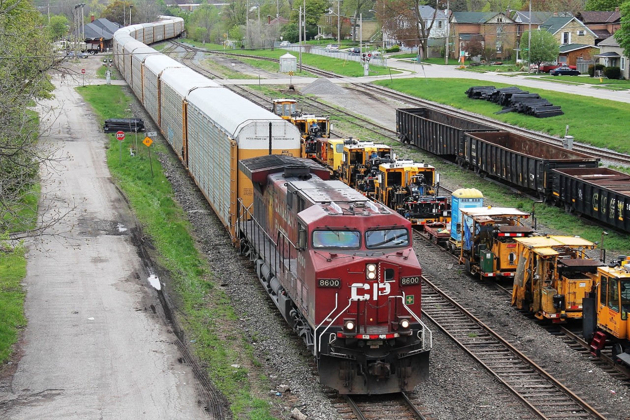 Galt yard as seen from Dundas Street overpass with 8600 hauling empty autoracks east. The yard plays host to rail maintenance equipment. The train can be seen snaking it's way over the Grand River bridge and past Galt station.