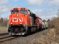 A short solo GE mixed freight train flies south by Richmond Hill at Weldrick. The railfan later missed a meet between a grain train and CN 107 as the wind was nearing 40kp/h, and he decided to go.