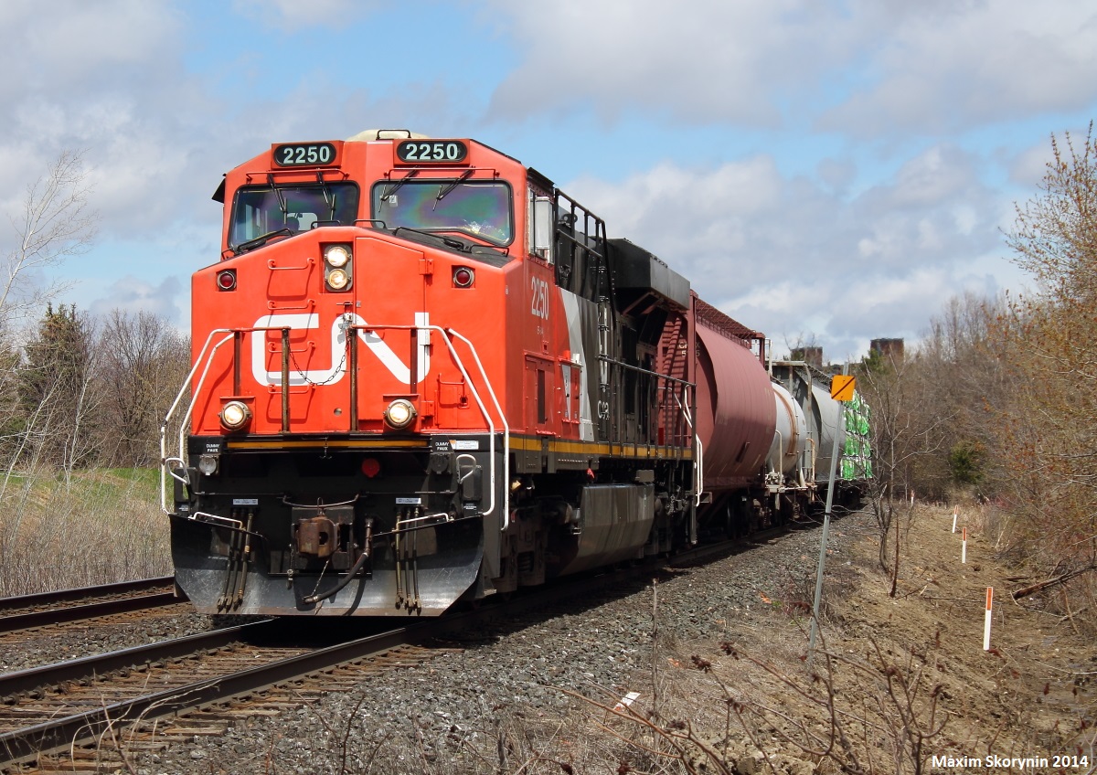 A short solo GE mixed freight train flies south by Richmond Hill at Weldrick. The railfan later missed a meet between a grain train and CN 107 as the wind was nearing 40kp/h, and he decided to go.