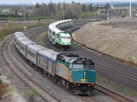 VIA Rail racing GO Transit.... on 2 different subdivisions! Here we see 2 Eastbound passenger trains "racing". The VIA Rail is on the CN Kingston subdivision and the GO Transit is on the GO GO subdivision. Since the Lakeshore East Line is one of the most heavily used by GO Transit, they decided to build their own subdivisions right next to CN's. Anyone notice the difference in ballast?