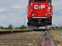 The "Kawartha Lakes Railway" or "The Havelock" sits at Havelock yard waiting for a crew to come and depart towards Toronto with a restriction of 15 mp/h due to bad track conditions. A low down rail shot with a small reflection can be seen here at Havelock yard.