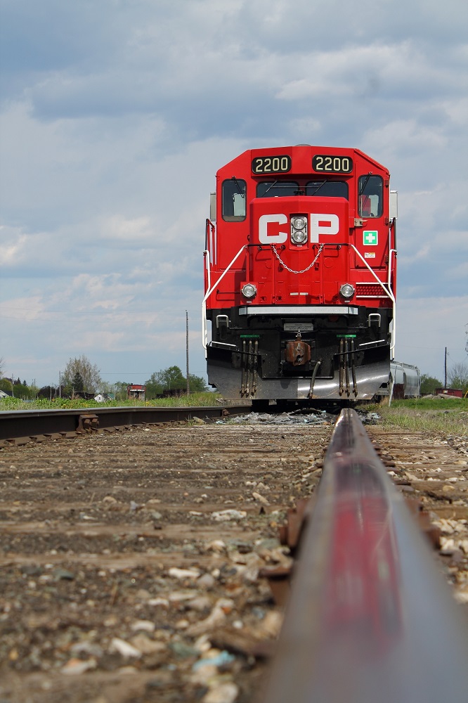 The "Kawartha Lakes Railway" or "The Havelock" sits at Havelock yard waiting for a crew to come and depart towards Toronto with a restriction of 15 mp/h due to bad track conditions. A low down rail shot with a small reflection can be seen here at Havelock yard.