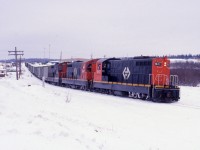 Christmas week 1987 finds Engineer Ray Boyd at the controls of Terra Transport Mixed Extra 941 West about to depart from Grand Falls for Corner Brook. Just days after this photo was taken, a CTC rule saw the coach service removed from the consist until the following April. For the first three months of 1988, Terra Transport would operate the train formerly known as # 203 as a freight only service.This photo with it's modern day counterpart  and many others can be seen in 'RAILS ACROSS THE ROCK - A Then & Now Celebration of the Newfoundland Railway' by Kenneth G. Pieroway and published by Creative Book Publishing of St. John's, Newfoundland. Photo by author. 