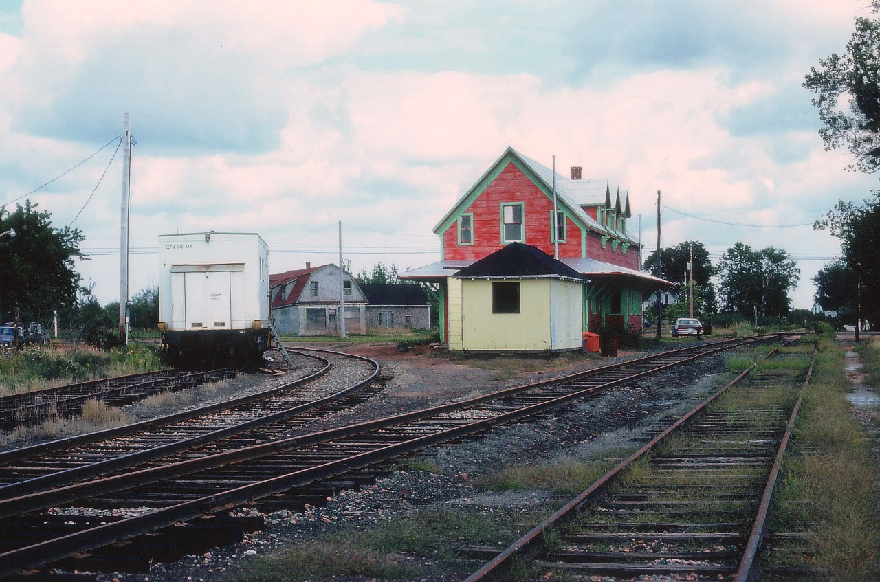 Another one of those unique station buildings I so enjoy. This one at the junction of CN Souris Sub (off to the left) and Montague Sub (on the right). The old station by 1981 had lost its' freight shed (far side) and was being converted to a restaurant which might have had a very short life, if one at all, as the building was moved not too long after. Point Deroche, about 8 KM to the north, is now where the station resides as a B&B, leaving a void in the once important railroad village of Mount Stewart. In the photo, the line to Souris looks reasonably well used, for it is potato harvest season on the Isle.