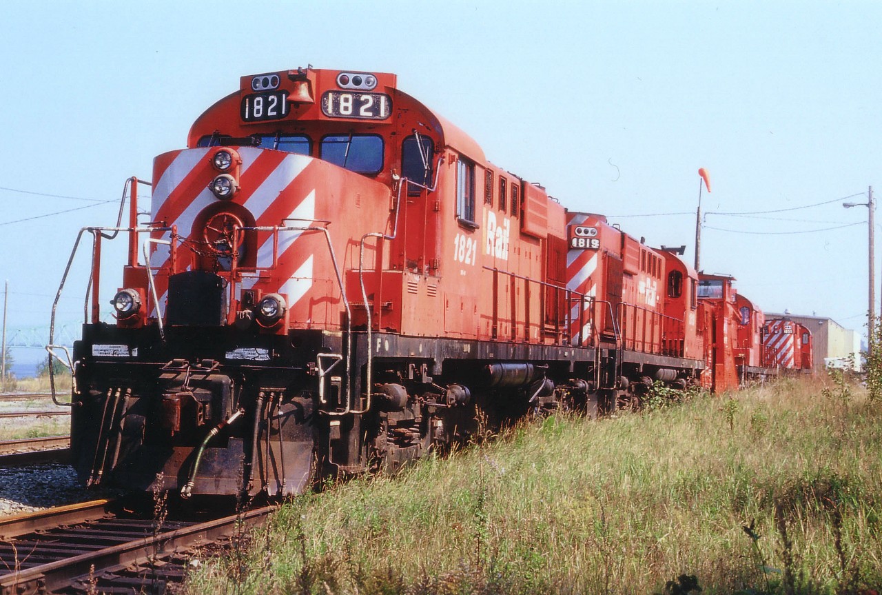 Lineup of interesting power at the old NBEC facility in Campbellton sees four former CP RS-18u locos with a plow  between. The units retained their former CP numbers but the "CP" on the flanks was painted out and replaced with a cruddy "NBEC". One would suppose with 25 of these engines on the roster, painting was out of the question. As it turned out, the NBEC, beginning life as a subsidiary of Quebec Railway Corporation on Jan. 28, 1998, with their mainline the former CN secondary main thru the province,  stumbled along until being bought back by CN in 2008. Another fallen flag. The locos pictured from front to back are x-CP 1821, 1819, plow 55419,  1866 and 1835. To the extreme left by the 1821 one can just make out the bridge over the Restigouche River to Quebec.