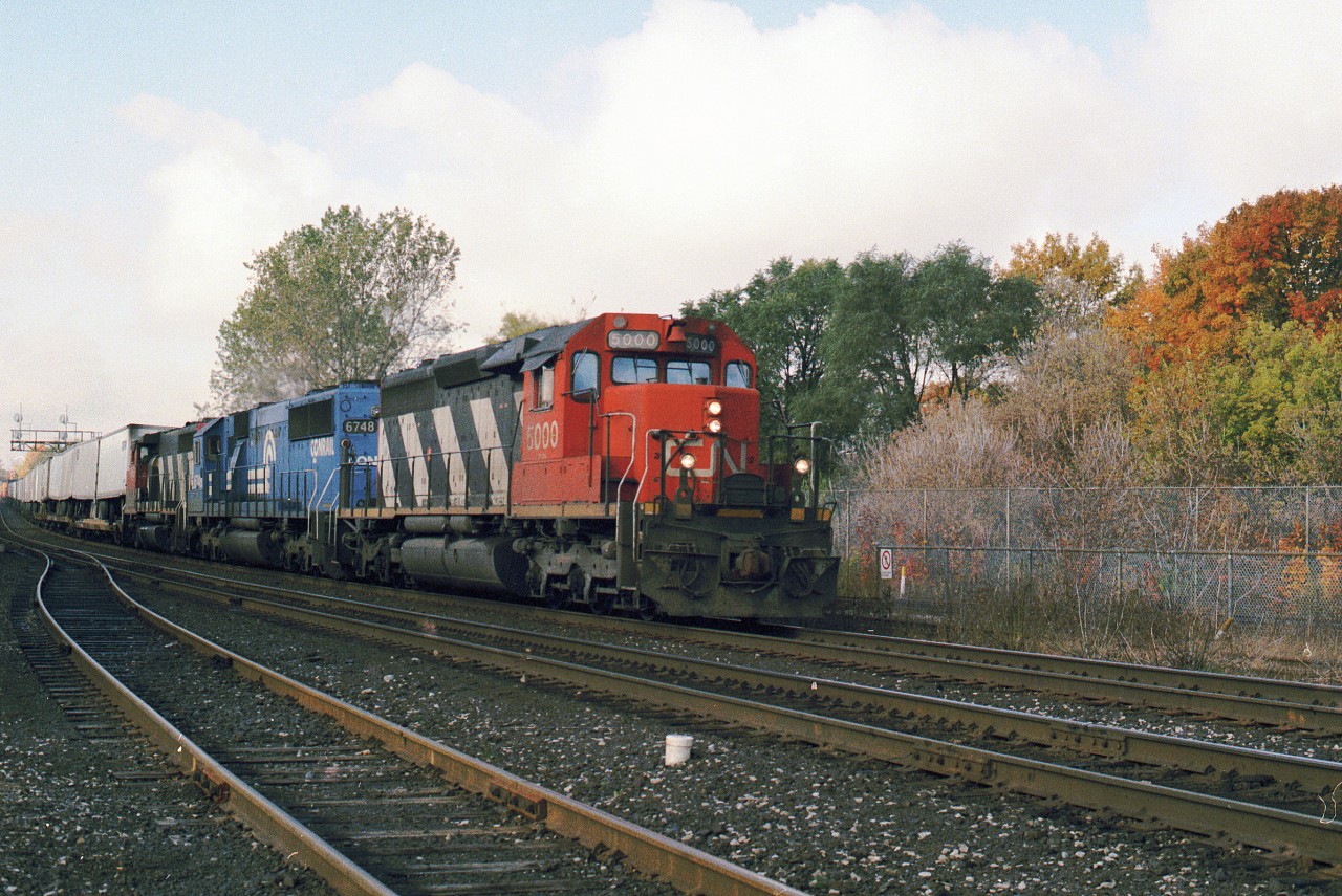 CN5000 in pretty good shape leads 144 on semi nice fall day with a Conrail in the consist