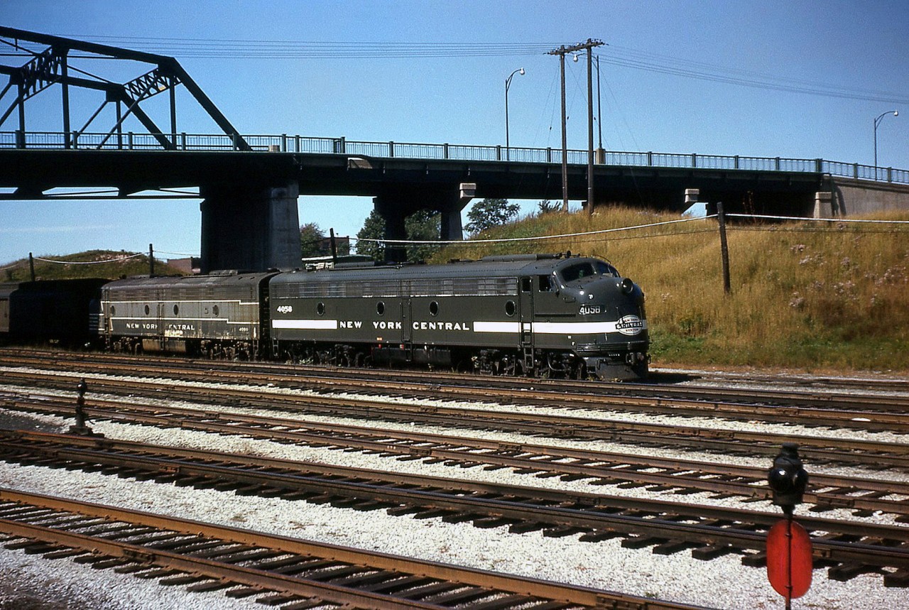 New York Central E8 4058 leads another sister E8 on the Niagara Rainbow at Fort Erie ON, before crossing the Niagara River into the states. The trailing unit is in the older Lightning Stripe livery, while 4058 wears a simplified version with a solid stripe coming from the "Cigar Band" logo, either recently painted or cleaned judging from how clean and shiny it is.