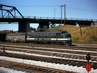 New York Central E8 4058 leads another sister E8 on the Niagara Rainbow at Fort Erie ON, before crossing the Niagara River into the states. The trailing unit is in the older Lightning Stripe livery, while 4058 wears a simplified version with a solid stripe coming from the "Cigar Band" logo, either recently painted or cleaned judging from how clean and shiny it is.
