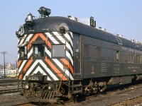 New York Central Rail Detector Car X8015 (by now operating under Penn Central, but still lettered NYC) rests at St. Thomas ON, on the Canada Southern division (CASO). A "Doodlebug", it was built by Brill in 1931 and served as a Rail Detector Car for the NYC (and later PC) for track inspection purposes.
<br><br>
Some notable things on this car are the lower lights pointed down and inward at the rails, likely for inspection purposes only. The miniature coupler, for "Emergency Only" use. The steam-era style bell, headlights and marker lights, and bent-down horn often found on Doodlebugs. As well, all the silver vents and equipment lining the rooftop of the car.
<br><br>
<i>(Geotagged location not exact).</>