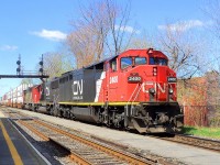 CN_2400 a C-40-8W leading loco follow of CN-5481 a SD-751 and a third locos that I do not have the number pulling a convoy of containers going in the Maritimes up to Halifax N.S. CN-route 120 