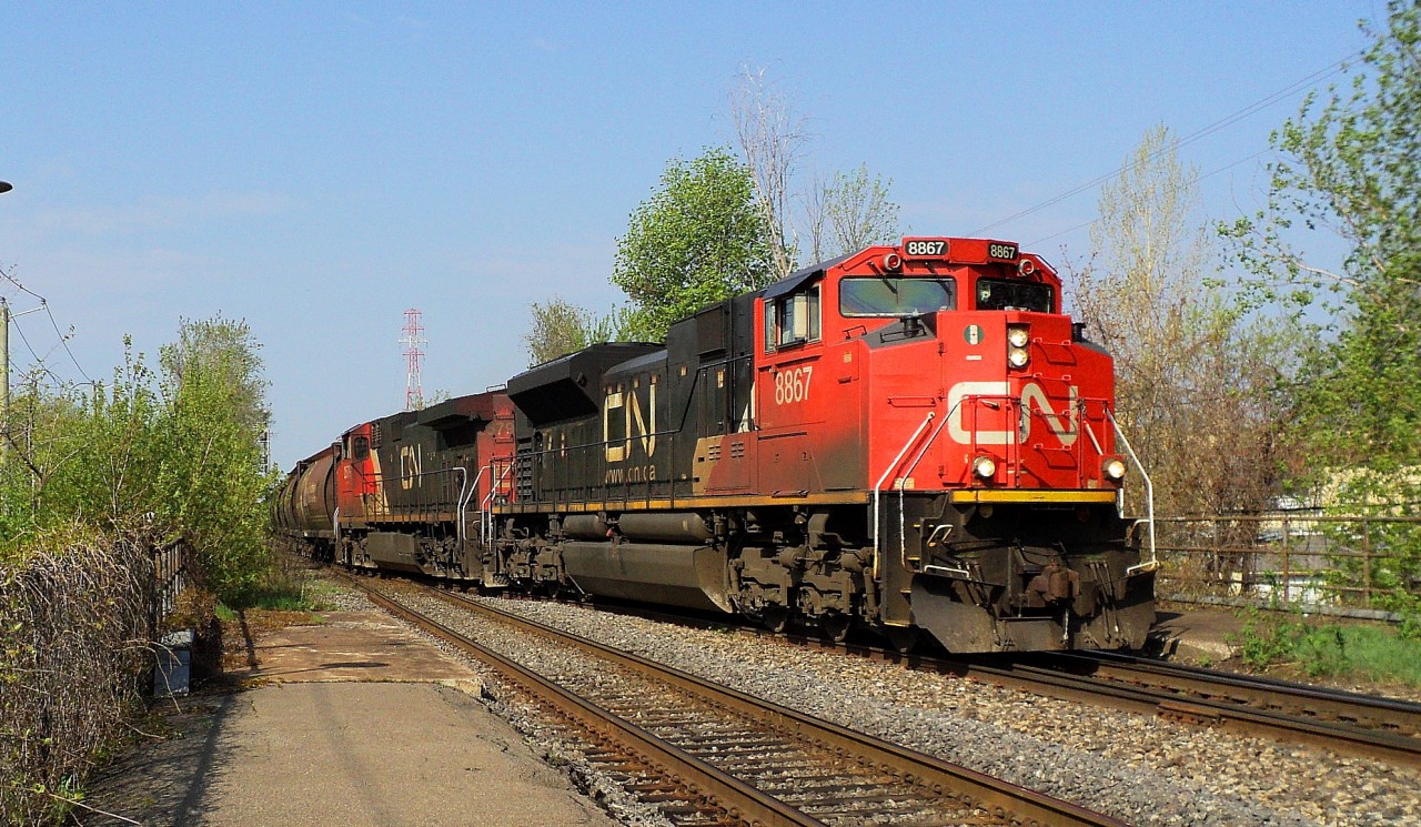 CN-8867 a SD-70M2 leading loco with CN2579 a C-44-9W crossing from South main track to North main track pulling a covoy of Covered hopper cars with wheat going in Halifax NS after Russia according CN employé