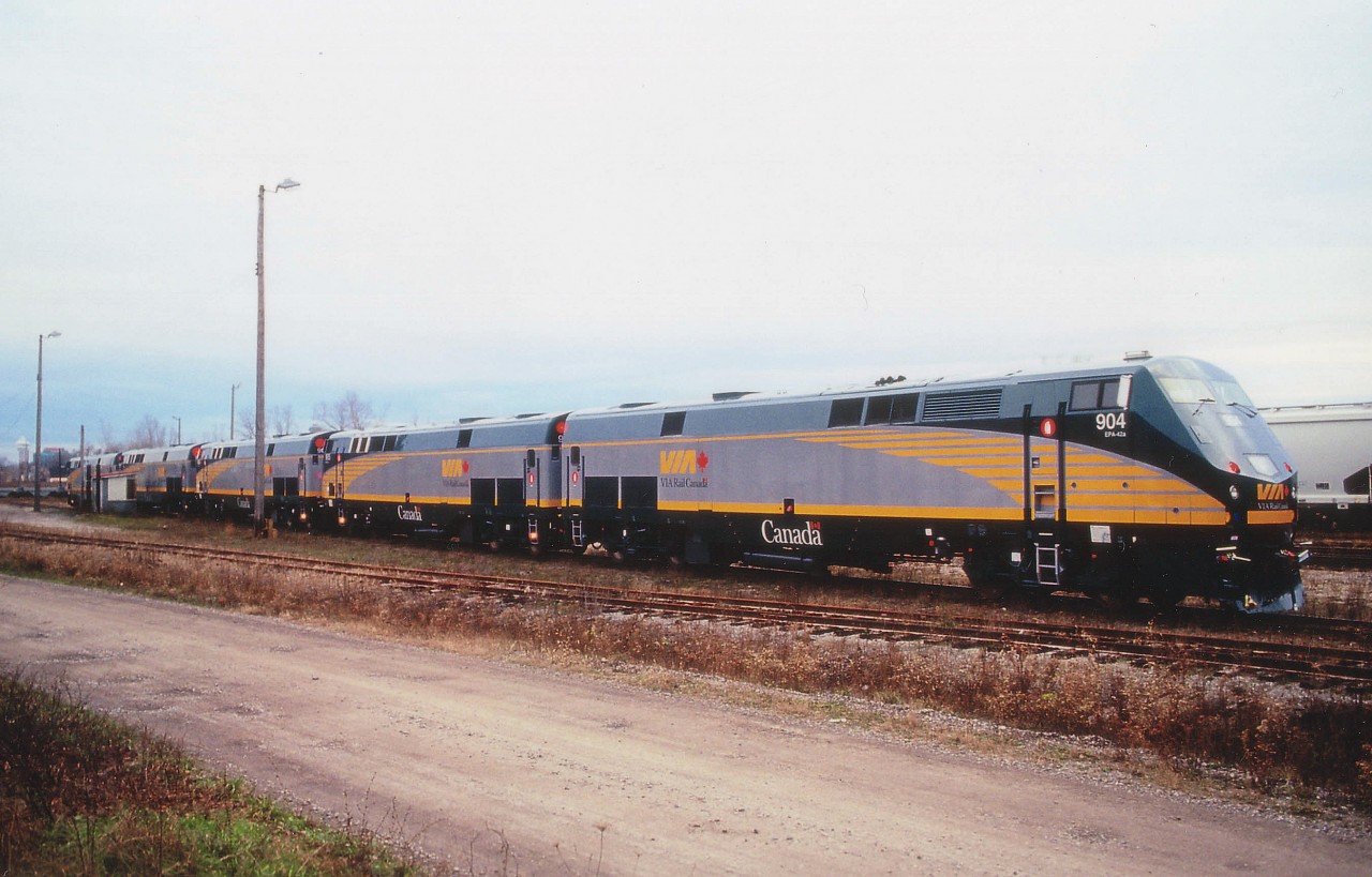 The VIA P42DC model locomotive is one that most fans are rather tired of, seen daily in the mid-section of the country, but very few witnessed their arrival new from GE in Erie, PA. In late 2001, they were delivered onto Canadian soil by NS #445, which was a transfer from Buffalo. As this train usually arrived late day and in the early winter daylight is short, the sun was often down before the train showed. In this view, five new units are seen late day in the old Niagara Falls CN yard just after delivery, a power-only special move by one NS unit. VIA 904, 905, 906, 903 and 907 will be moved to Toronto during the wee hours.