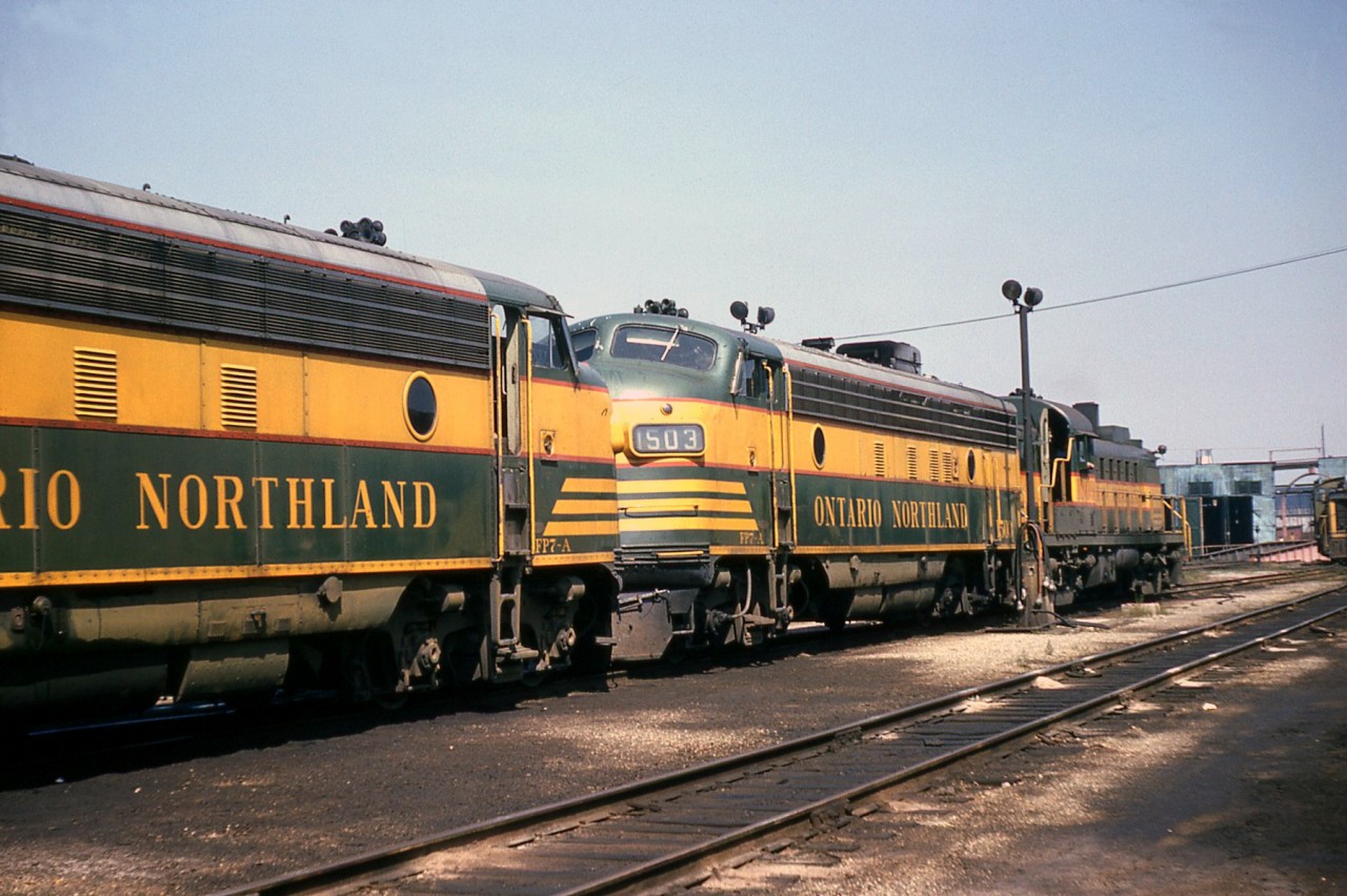 Ontario Northland diesel power is lined up at CN's Mimico Roundhouse for servicing. Shown here are a pair of GMD FP7's nose-to-nose (1503 and another 1500-series unit), with RS3 1309 further down. The Mimico roundhouse and turntable can be seen in the background, with part of a CN SW-series switcher to the side.

In addition to a joint CN-ONR Northland passenger train (that could often be found with an ONR F-unit operating with a CN F), ONR power sometimes ran on freights on CN. An example of that can be found here, shown passing Sunnyside on the way to Mimico: http://www.railpictures.ca/?attachment_id=14899.

For a shot of some big steam power at Mimico a few years earlier: http://www.railpictures.ca/?attachment_id=14024</a<